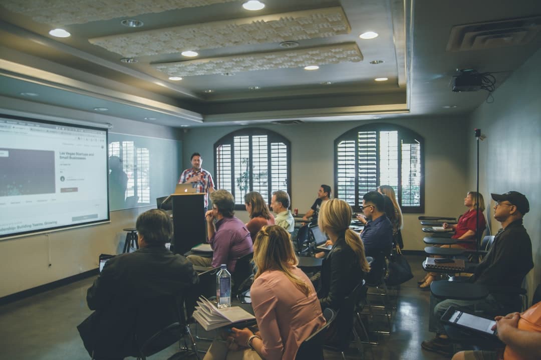 Students learning in a modern classroom with a projector, illustrating online education platforms