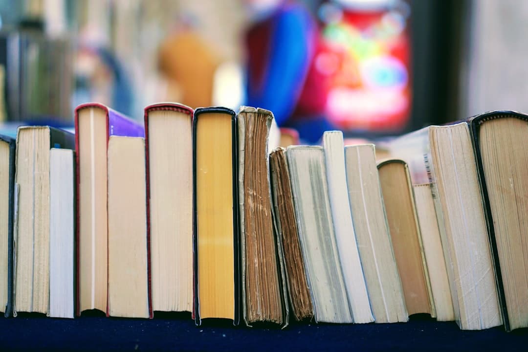 Author writing at a desk with books