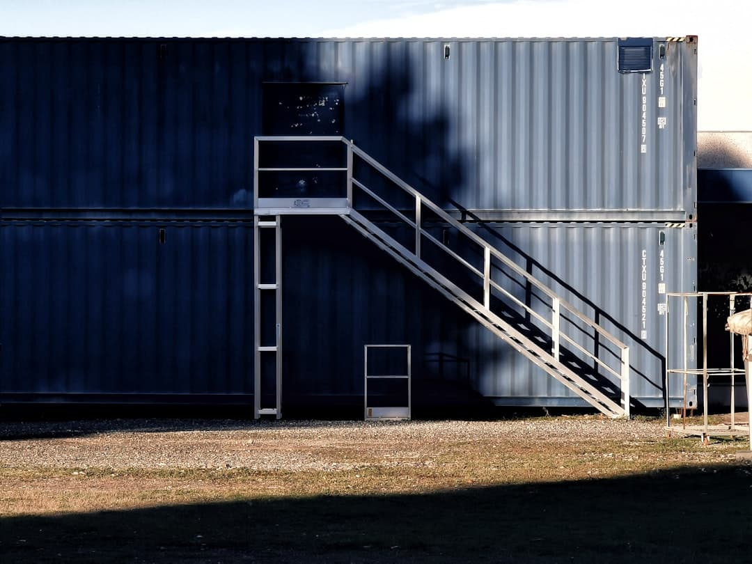 Shipping containers in warehouse representing logistics website design