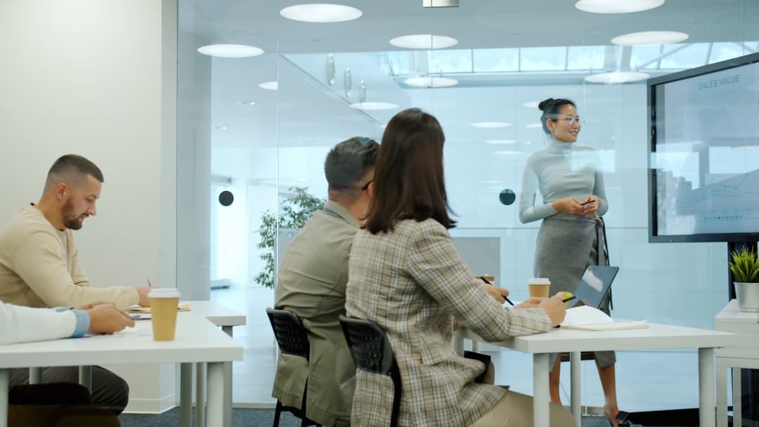 Sales team working with a CRM on multiple screens