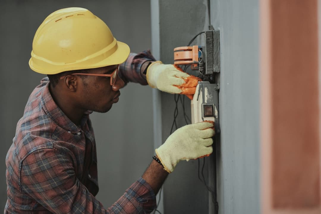 Electrician performing wiring work, illustrating electrician website design priorities