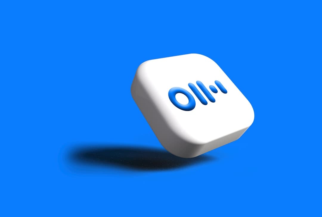 White cube with blue logo on blue background