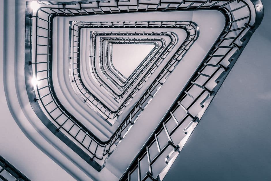 A captivating shot of a triangular staircase from below in Hamburg's modern architecture.