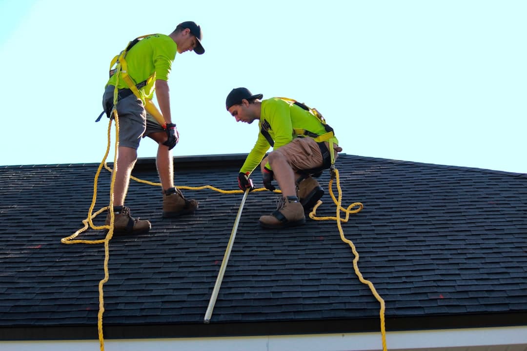 Roofer at work on a roof, illustrating roofing website design priorities