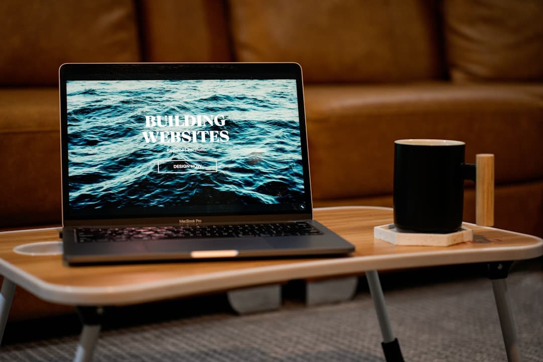 a laptop computer sitting on top of a wooden table